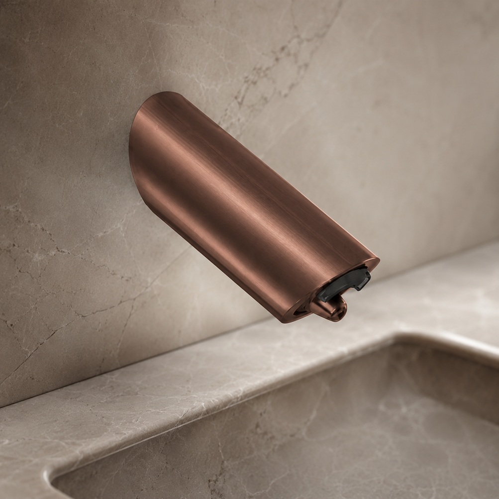 Brushed copper wall-mounted touchless faucet model with rounded cylindrical spout and black sensor nozzle installed above a stone bathroom sink
